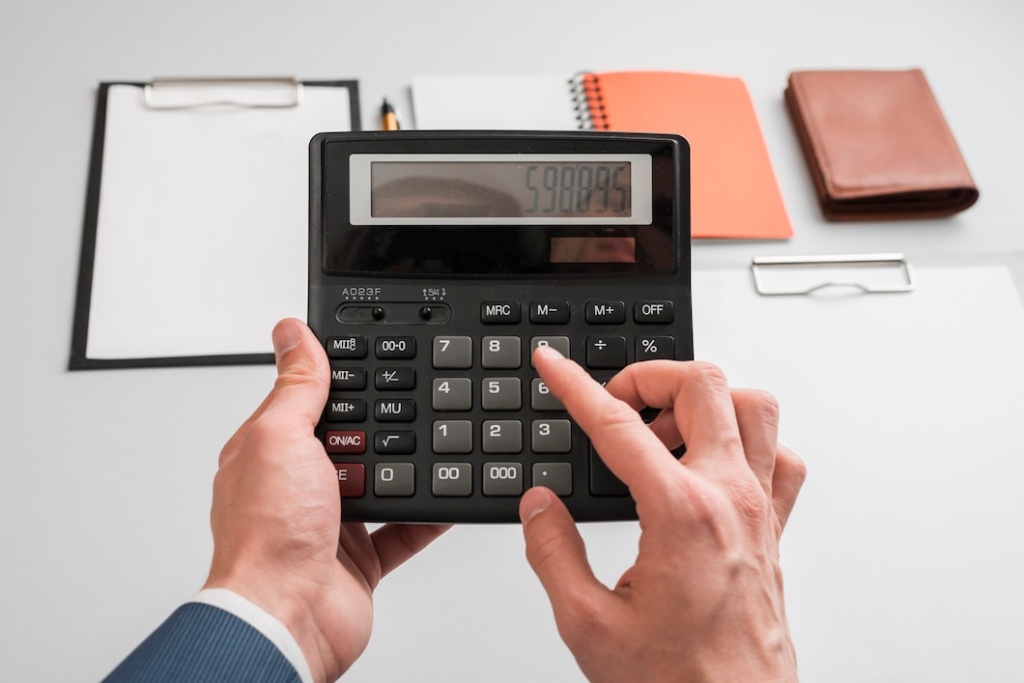 business-concept-with-hands-using-calculator_23-2147985101.jpg